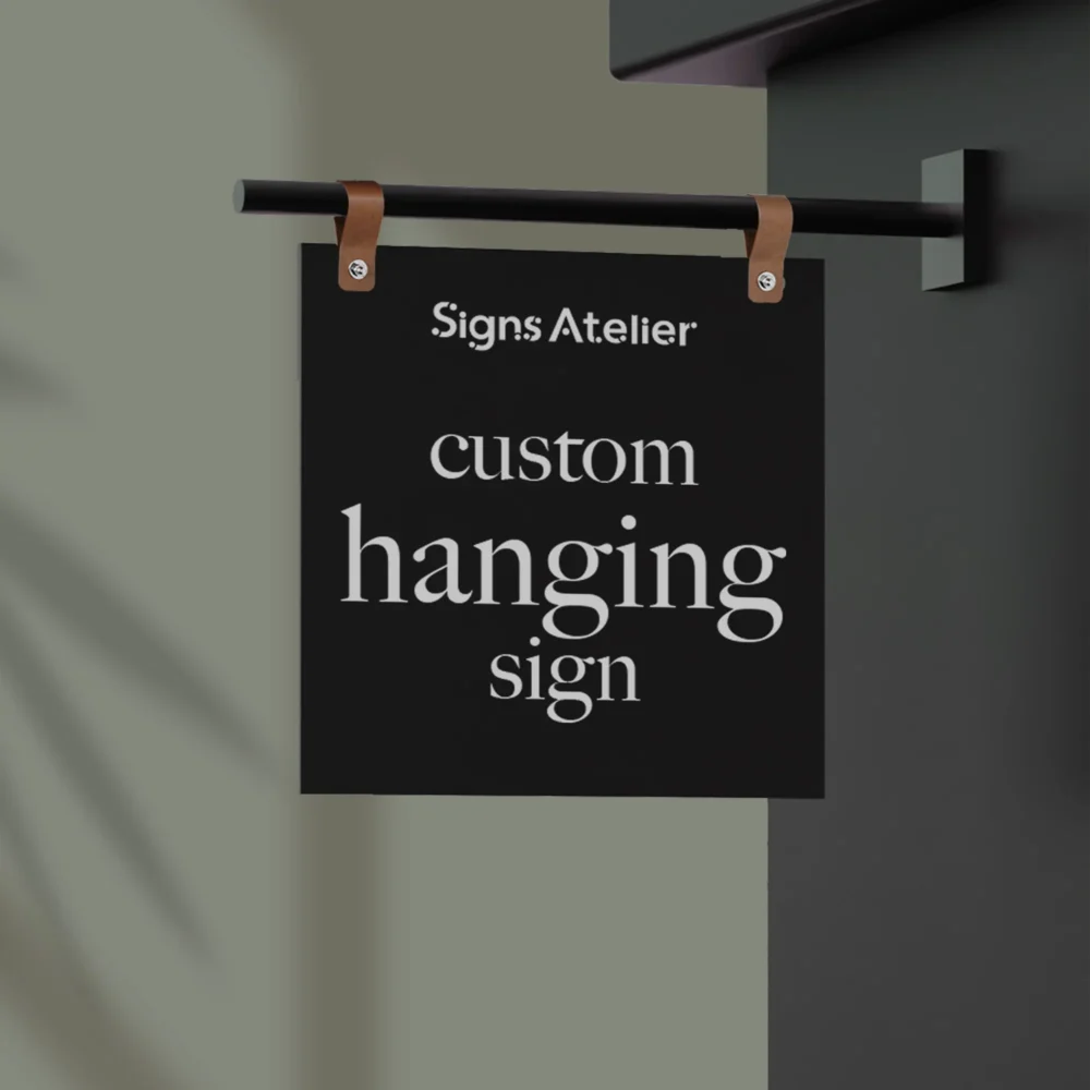 An image of the Custom Black Hanging Sign product with a logo print and hanging on the wall.