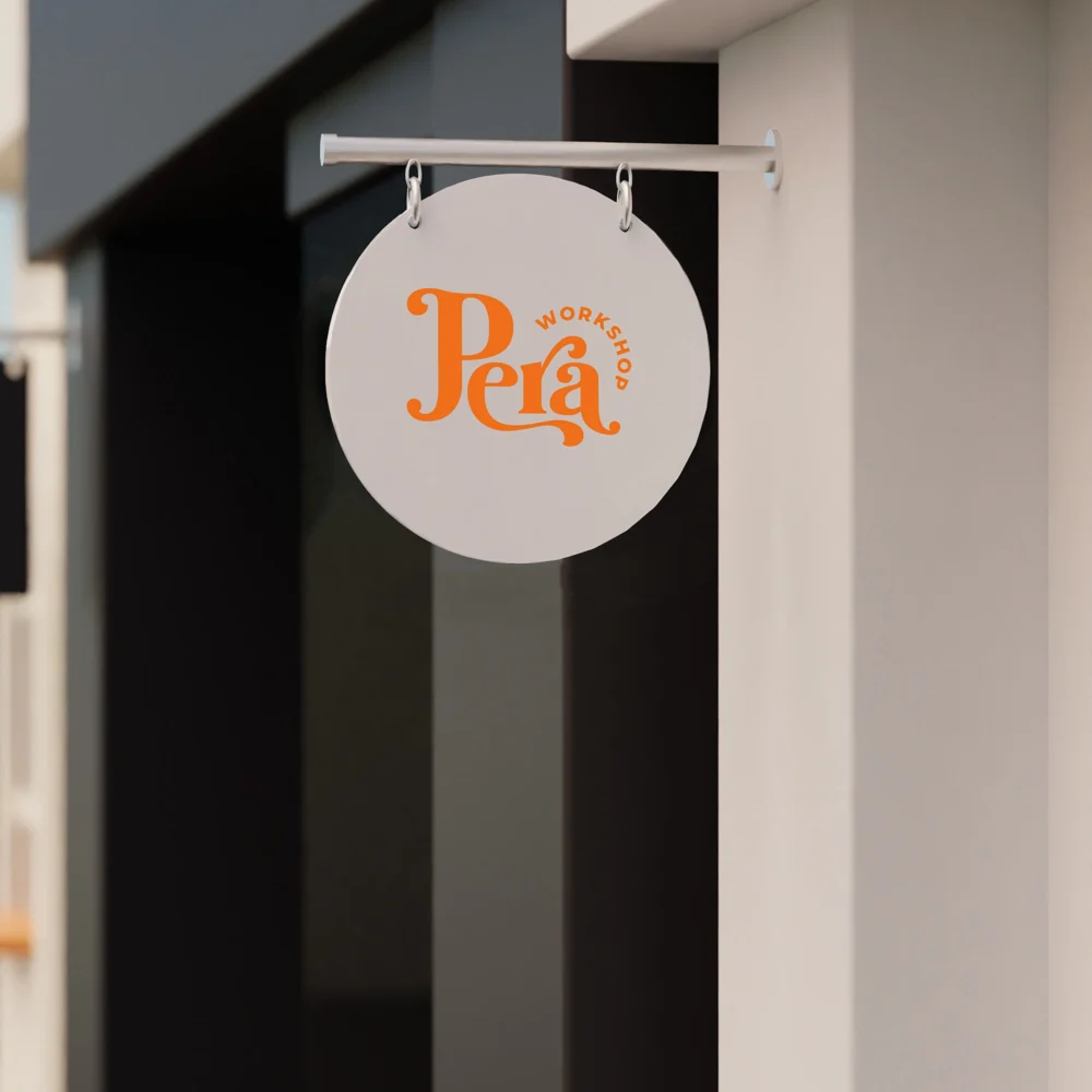 An image of the Custom White Hanging Sign product hanging on the wall with a logo print.