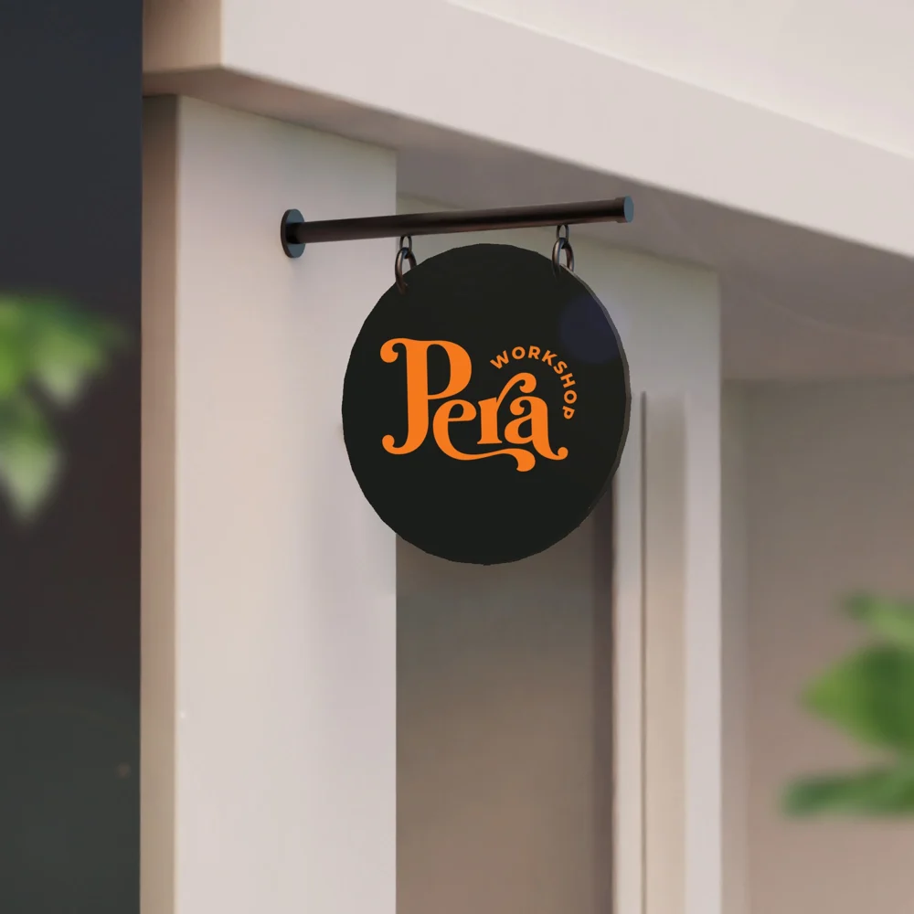 An image of the Custom Hanging Sign product hanging on the wall with a logo printed on it.