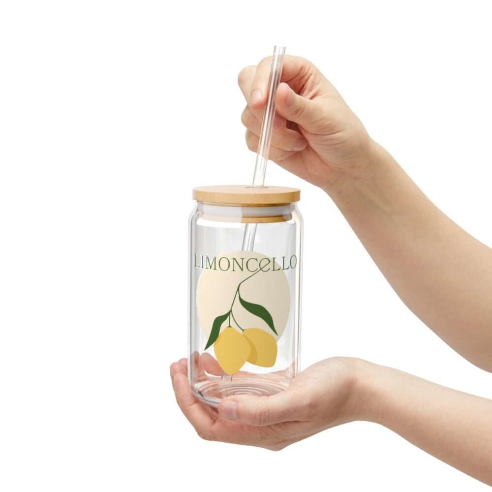 An image of the Custom Logo Printed Sipper Glass product. A person is holding the product. The product in the image includes a lemon logo.