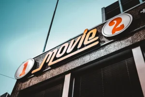 Cover photo of the article Business Signs 101: Ultimate guide to all types of signs. Photo shows an orange frontlit sign hung in front of a business.