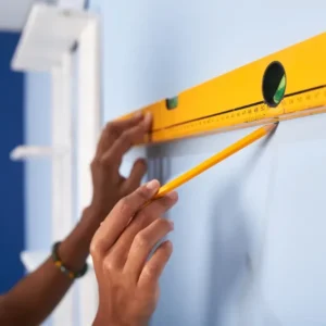 Photo from the sign installation topic on the Guides and resources page. In the photo, a business owner levels his sign to install it.